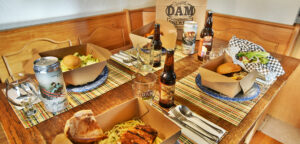 Dam Brewery take out meals and to go beers on home table